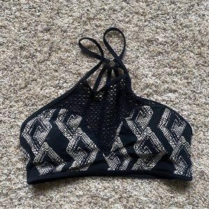 Reef bikini top. Size medium. Unique netting material at top. Black and cream